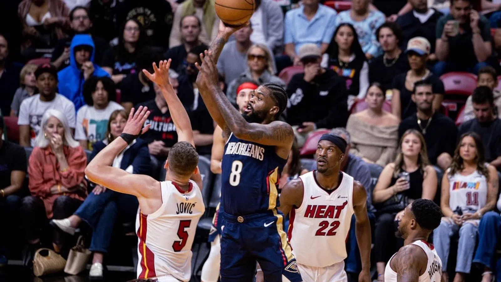 a group of men playing basketball