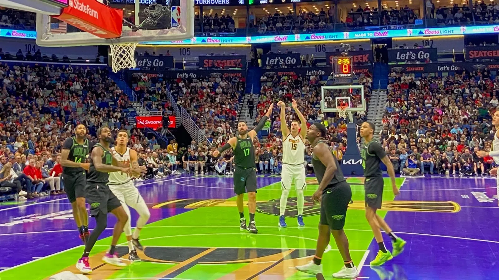 a group of people playing basketball in a stadium