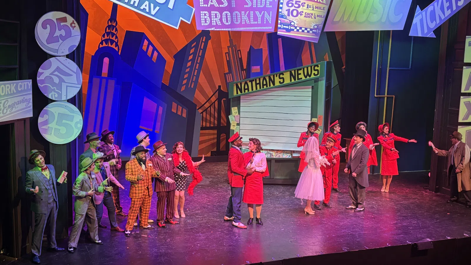 Colorful theatrical performance with actors in vintage costumes on a vibrant New York city themed stage.
