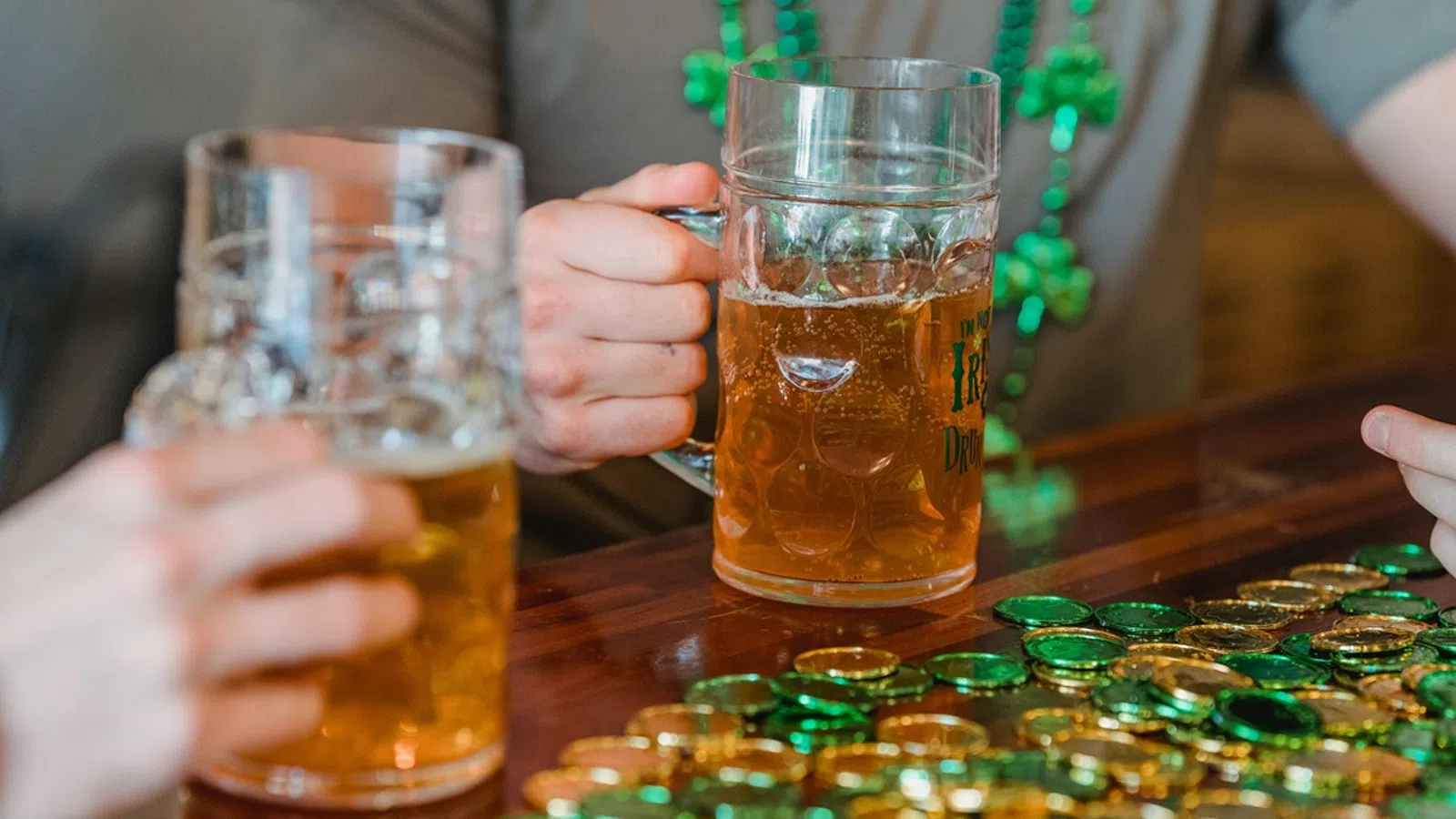 a group of people holding glasses of beer