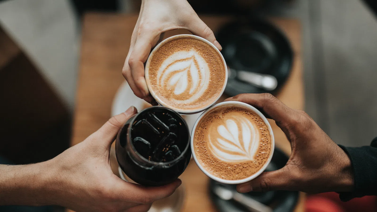 a person holding a cup of coffee