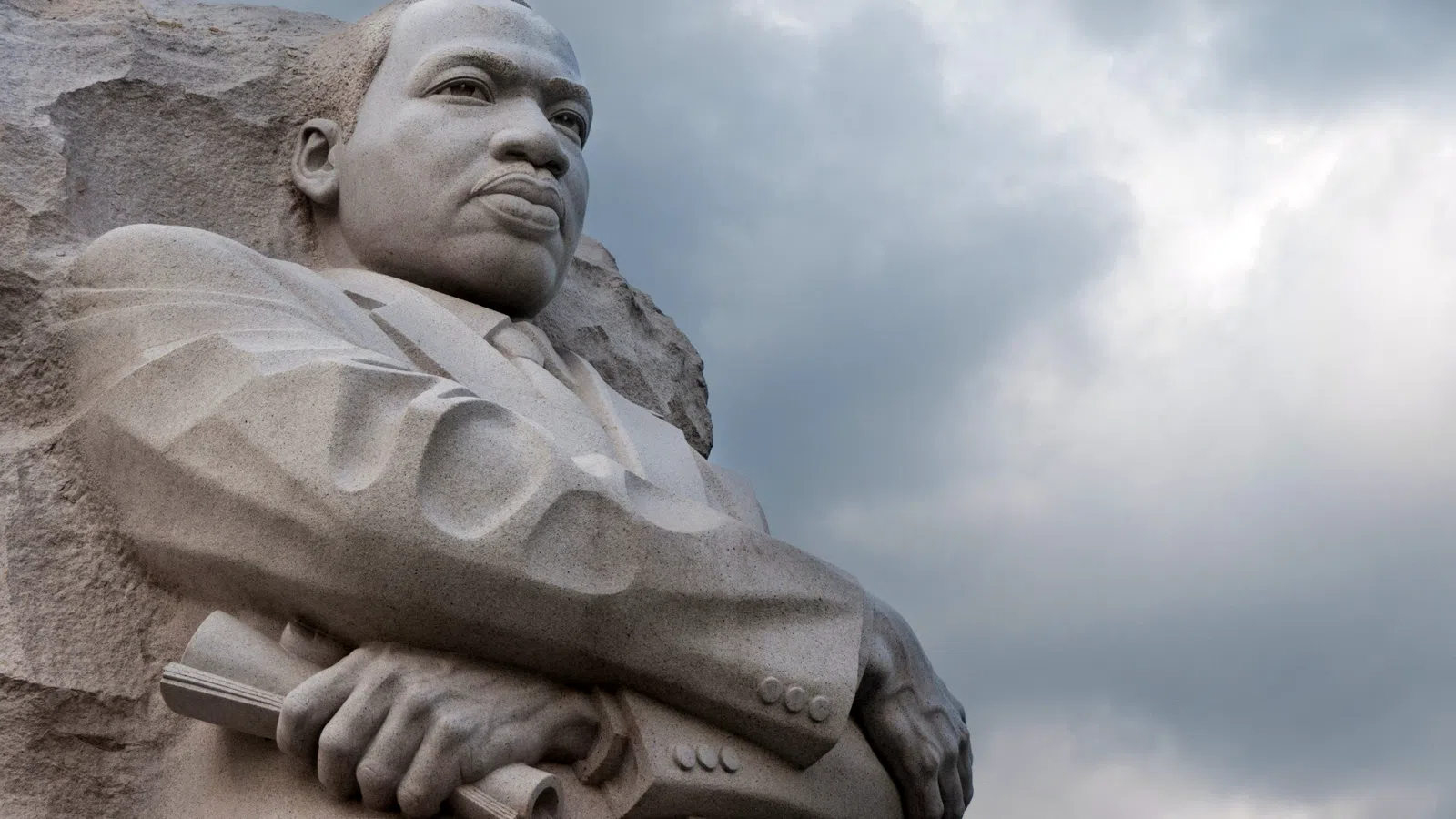 a statue of a man holding a book