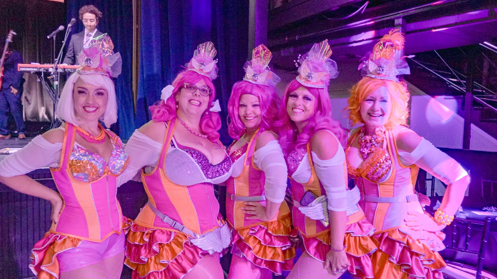 a group of women wearing pink and white clothing