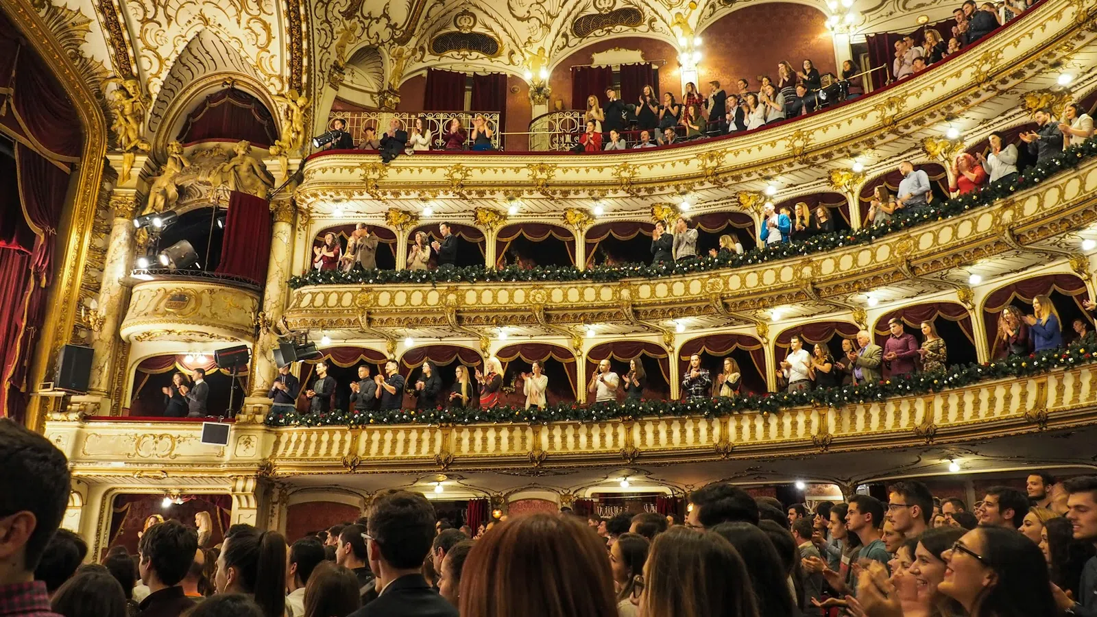 a group of people in a room with a stage and a large crowd