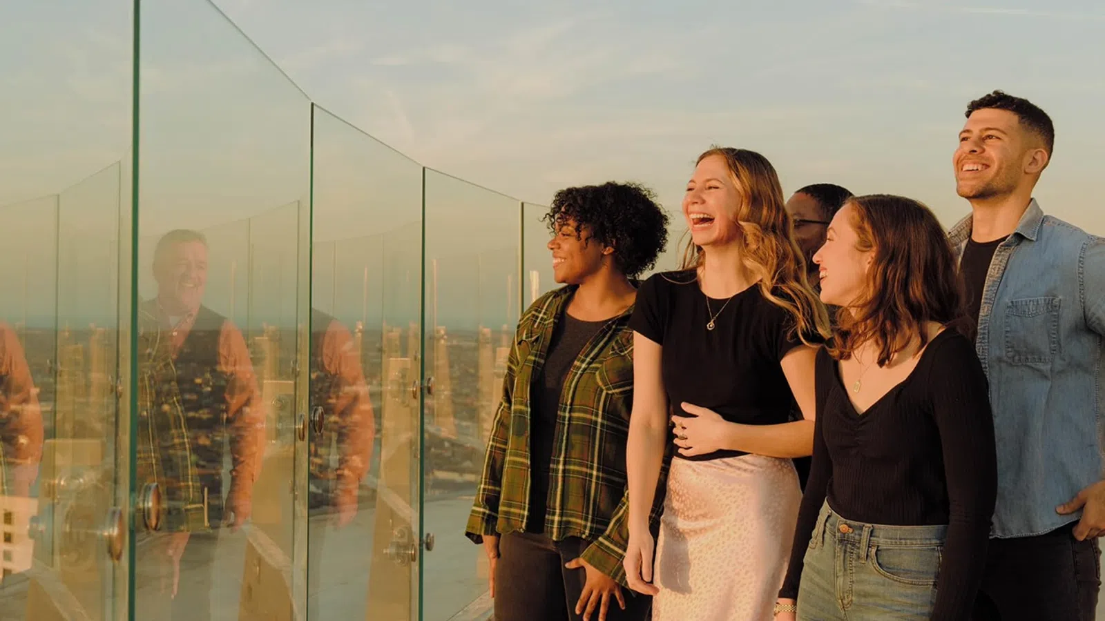 a group of people standing in front of a glass wall