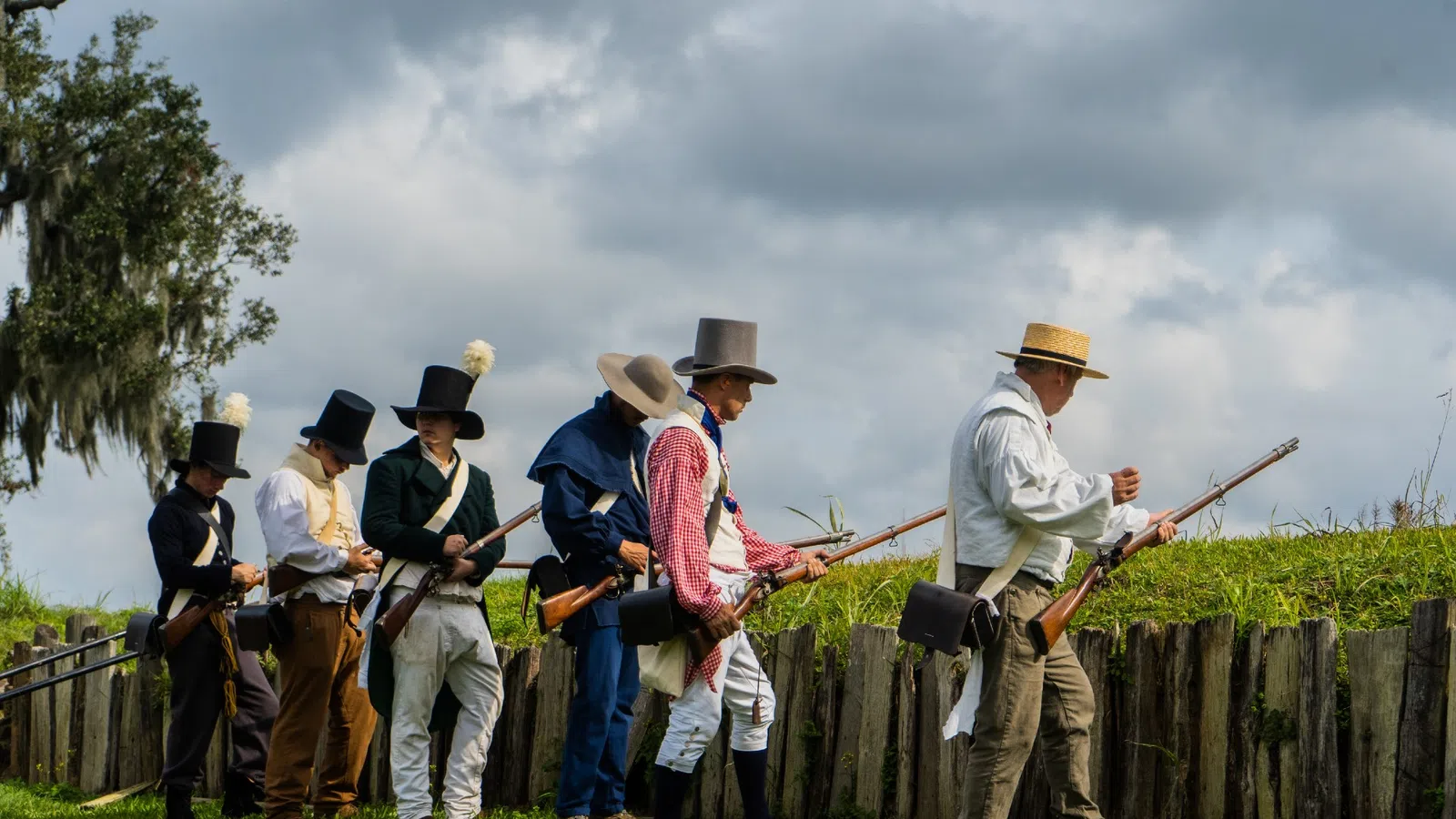 a group of people in cowboy hats holding guns
