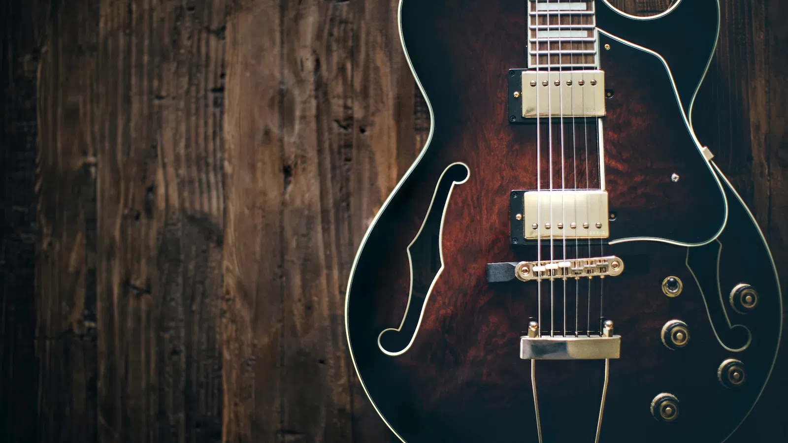a guitar leaning against a wall