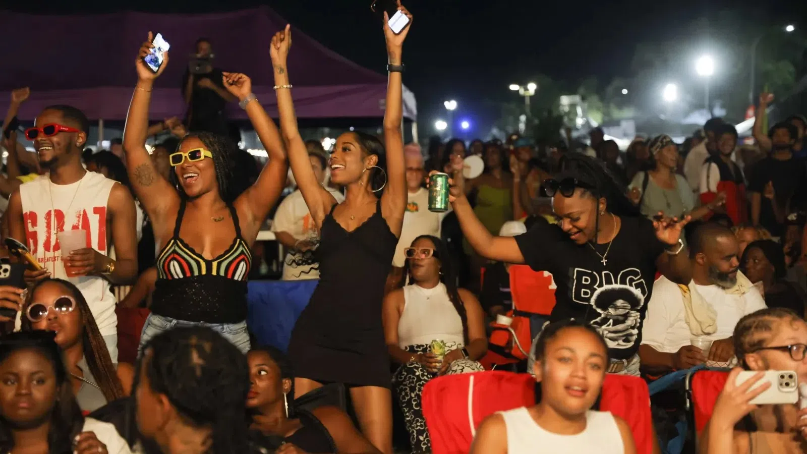 a group of people holding up their hands