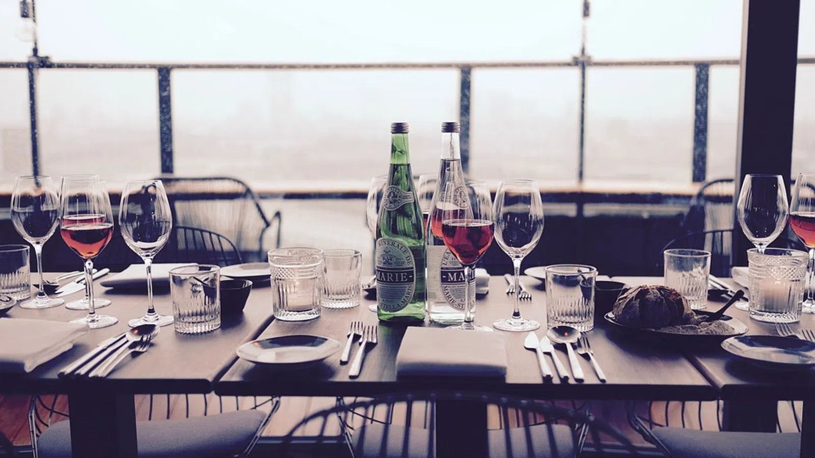 a table with wine glasses and bottles