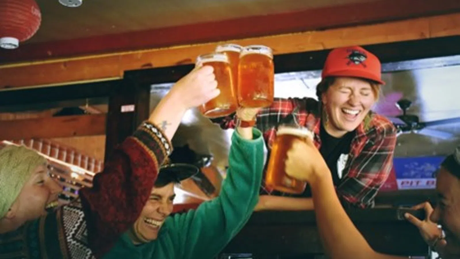a man holding a glass of beer