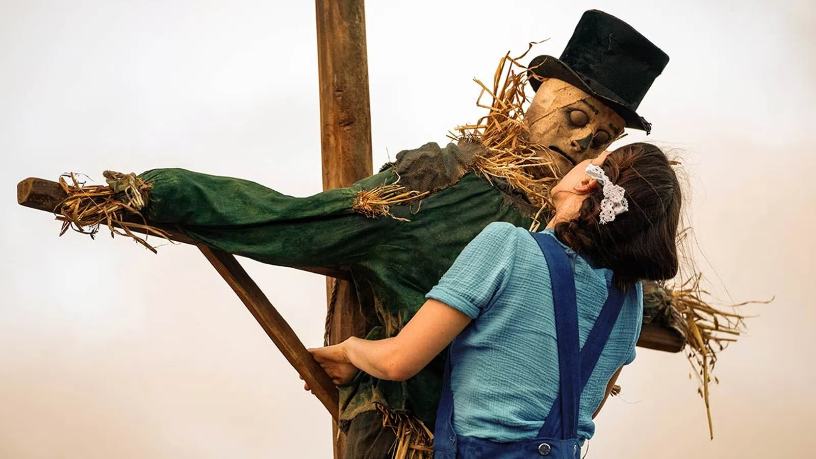 a man and woman holding a cross