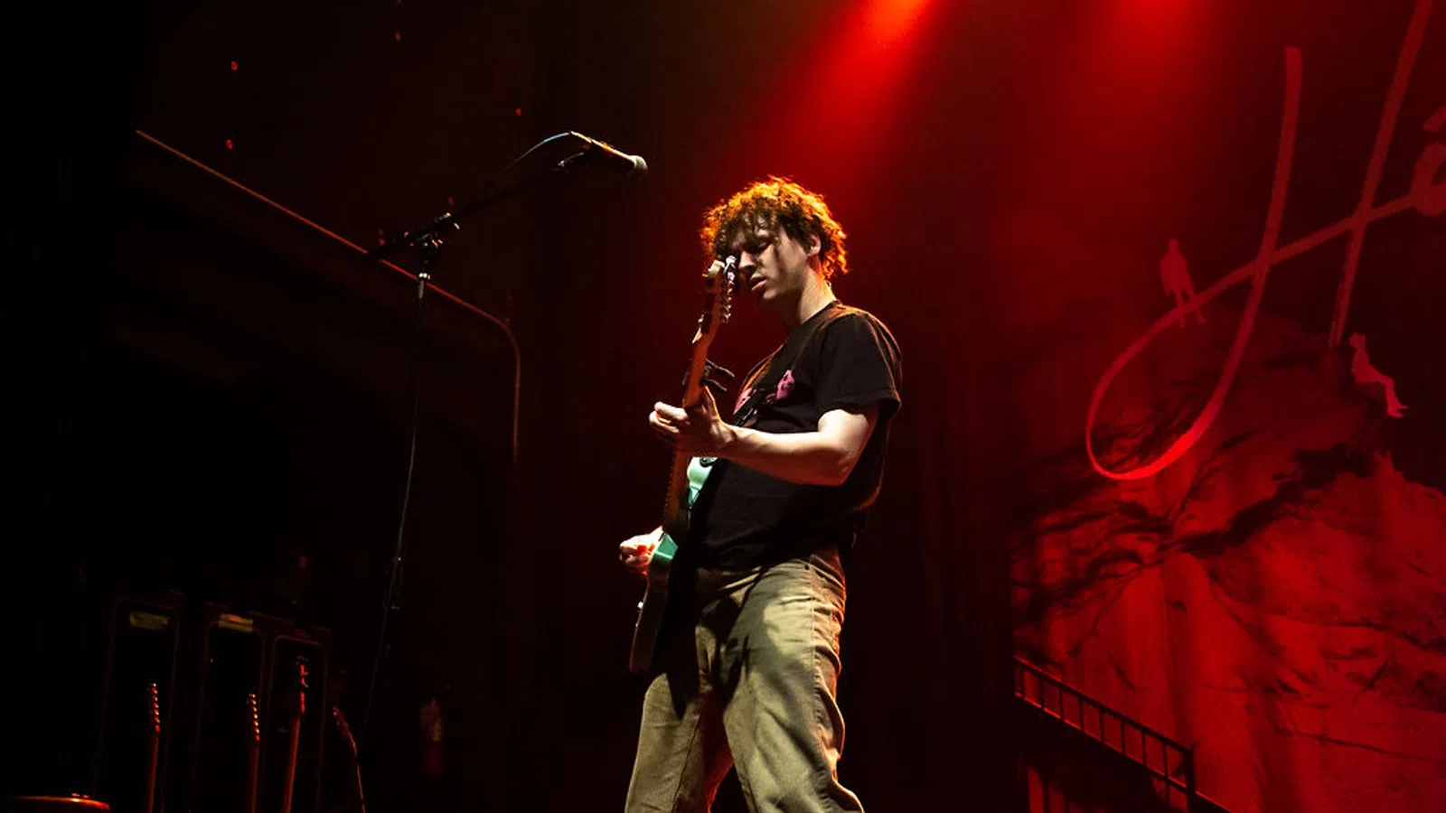 a man playing a guitar on a stage