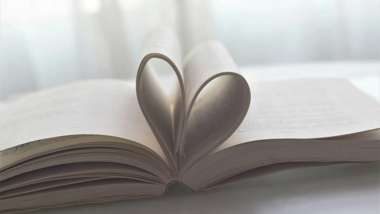 a pair of scissors on top of a stack of books