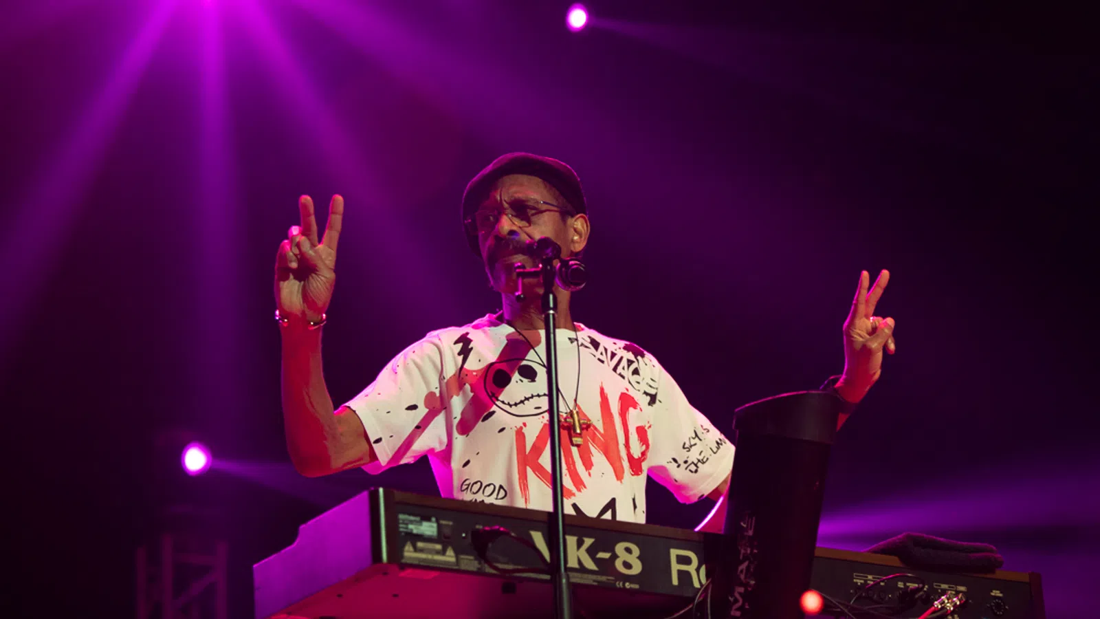 a person on a stage with the hands up and a microphone