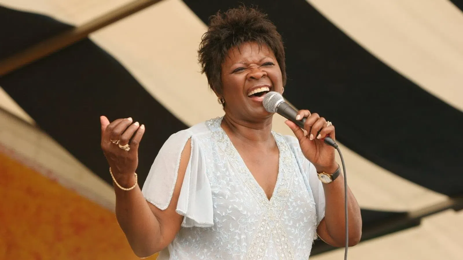 Irma Thomas singing into a microphone