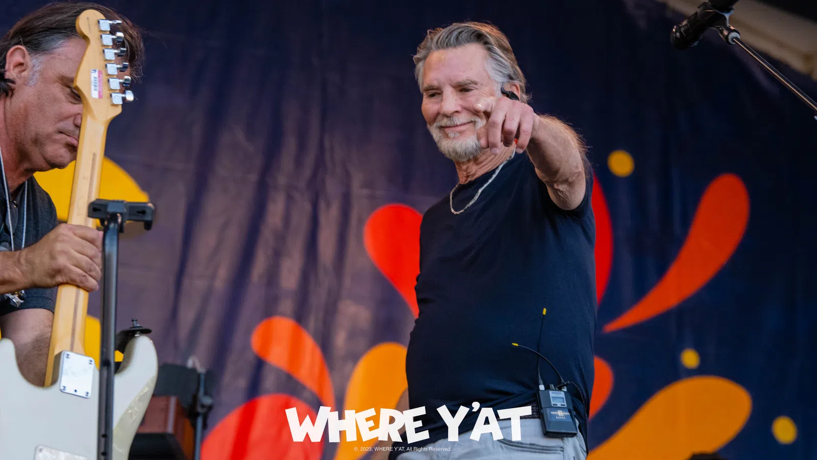 Kenny Loggins holding a microphone