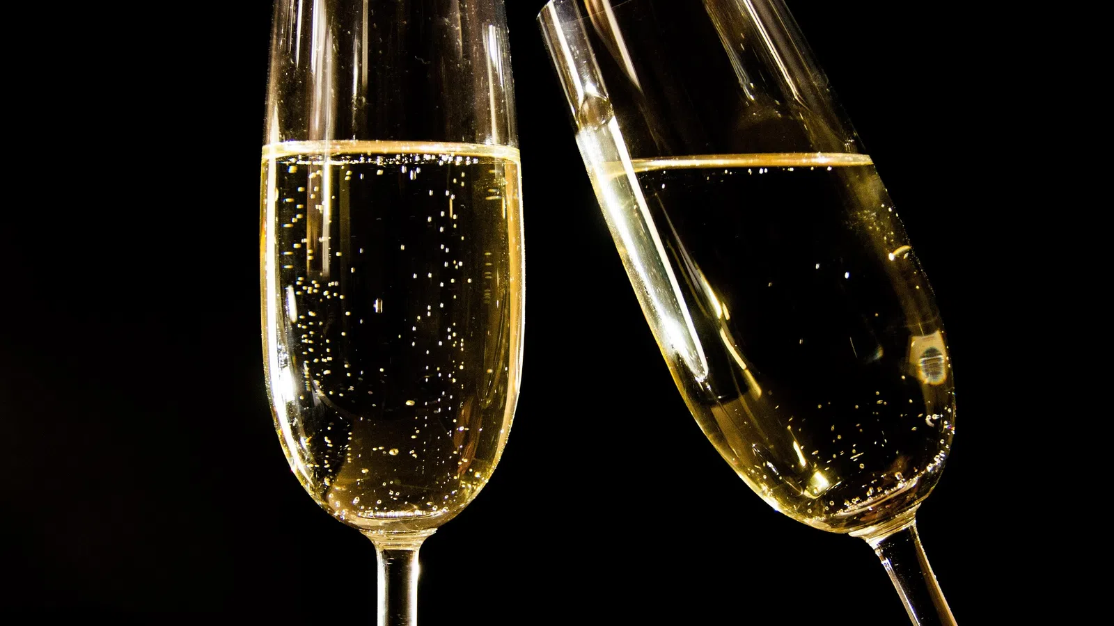 two wine glasses with white liquid