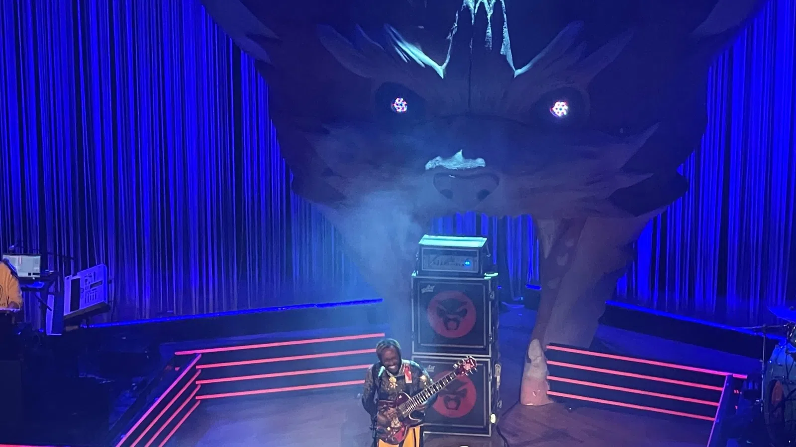 a person playing guitar on stage