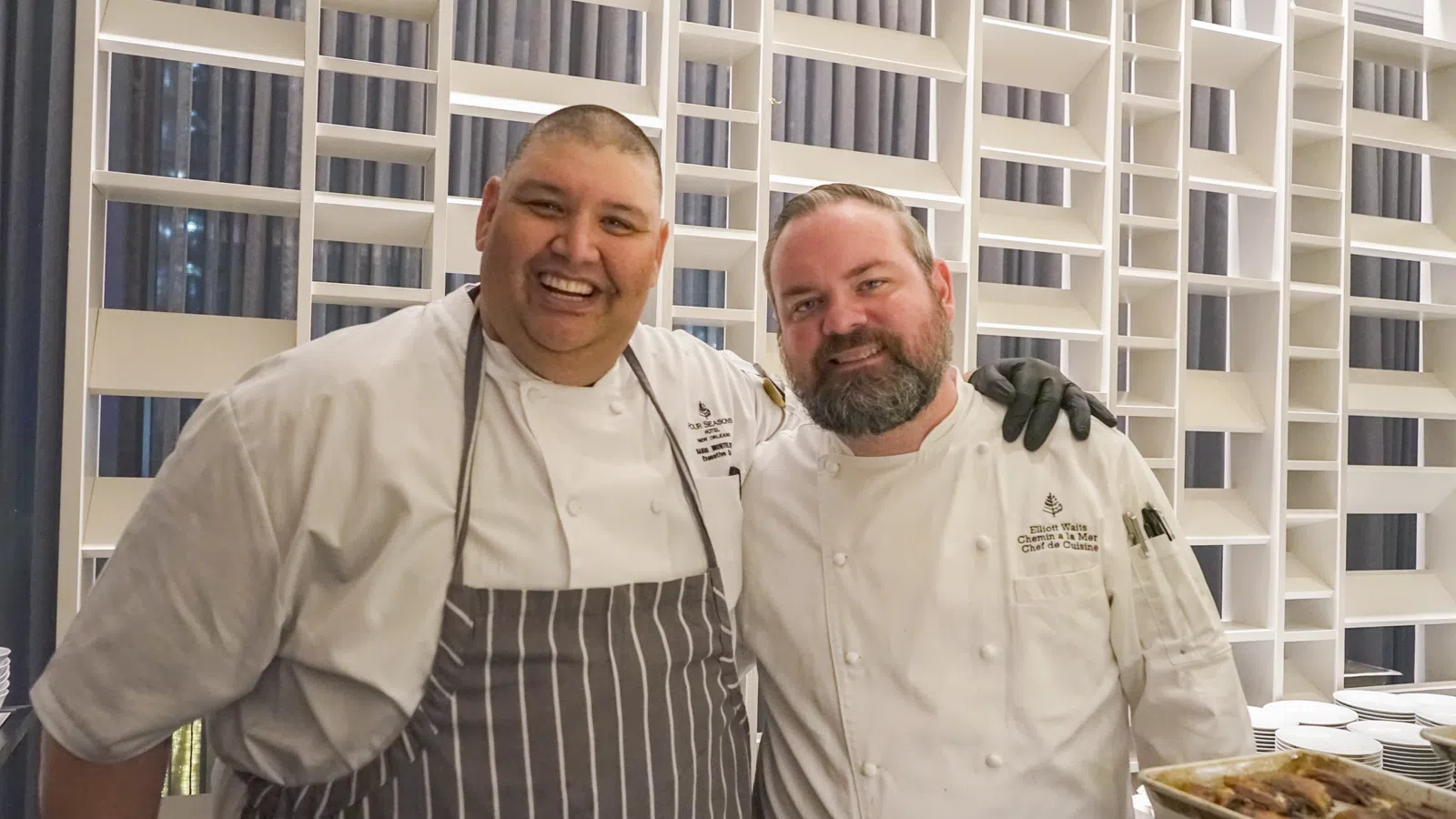 a couple of men smiling