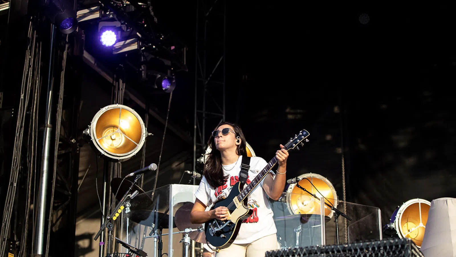 a person playing a guitar on a stage