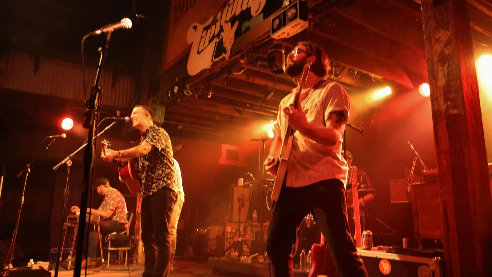 a group of people playing instruments on a stage