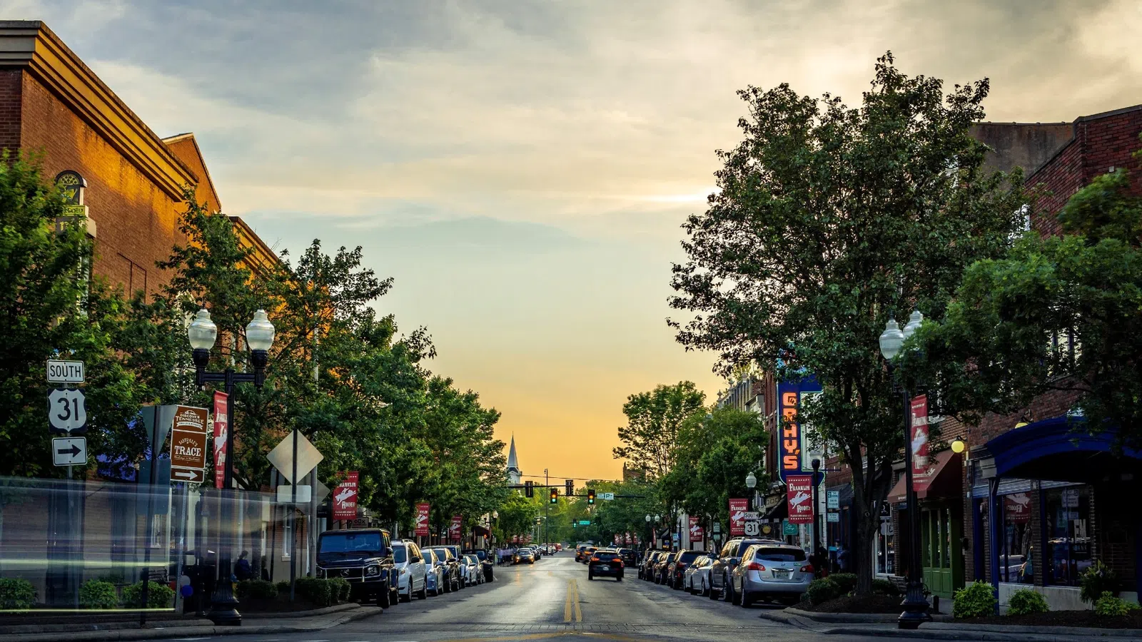 a street with cars and trees