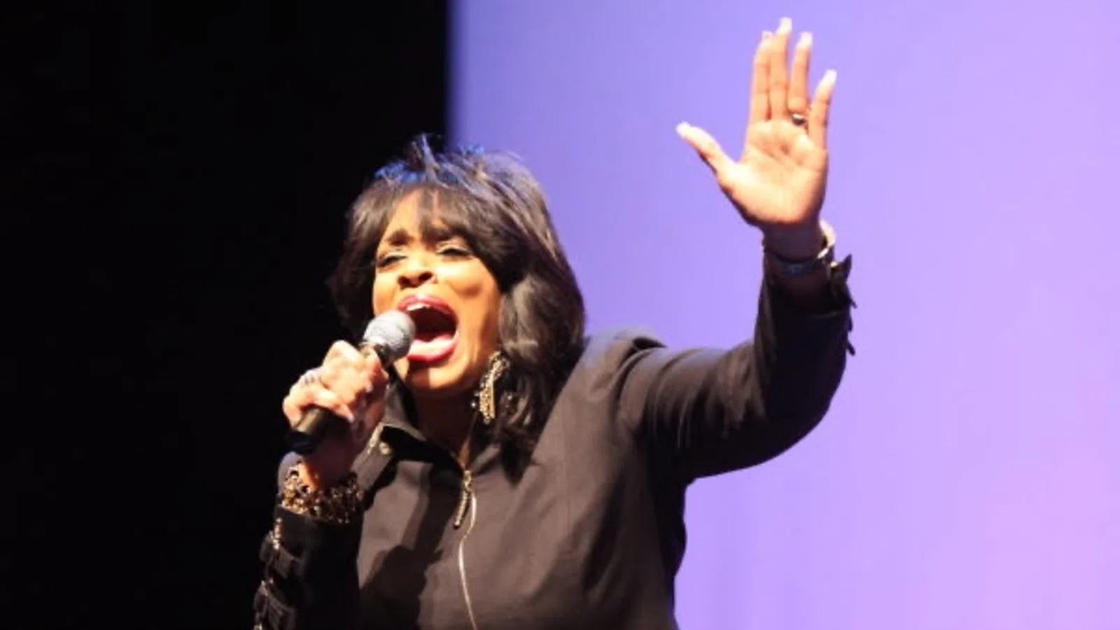 a person singing into a microphone