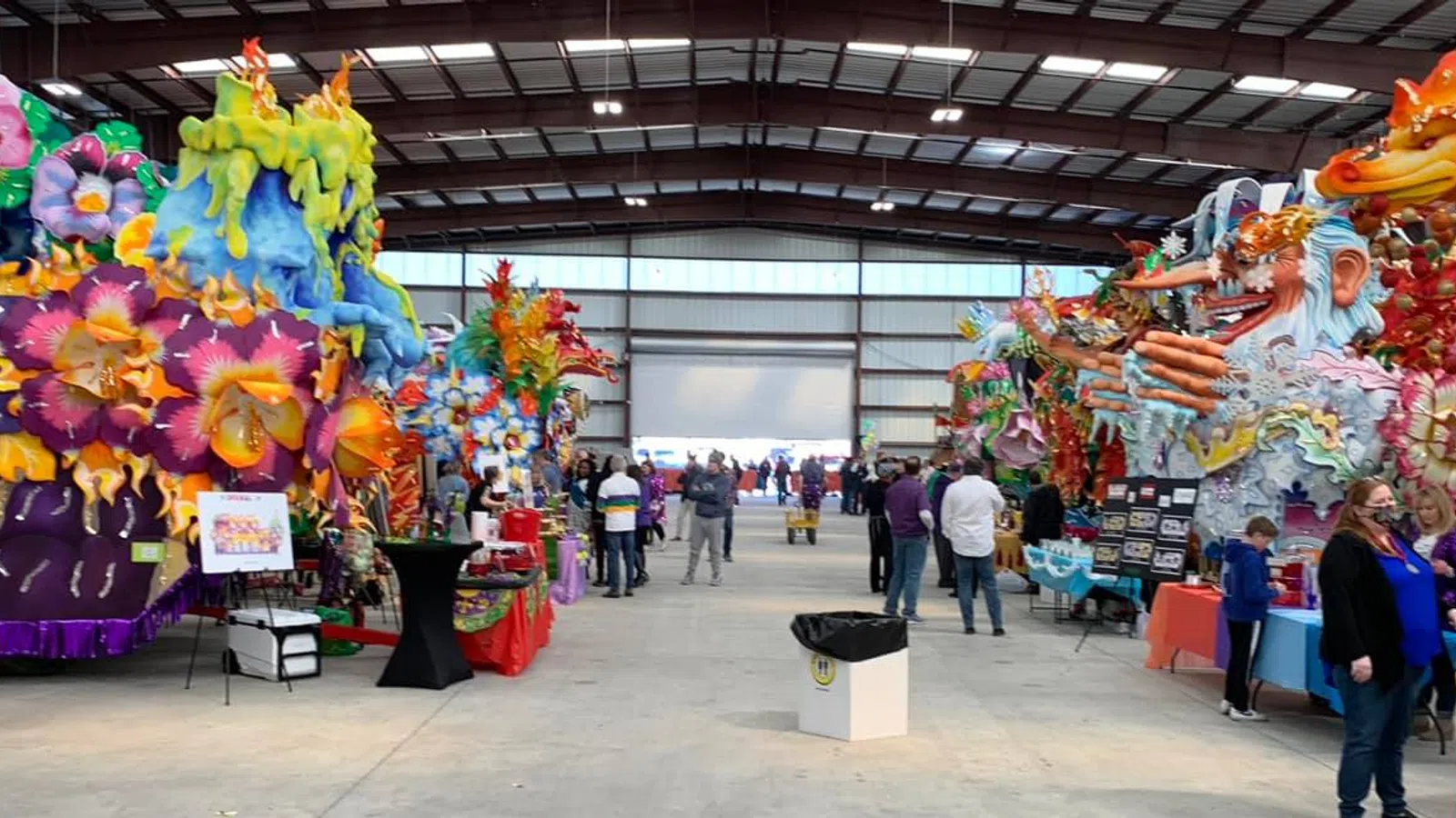 a large room with people and balloons