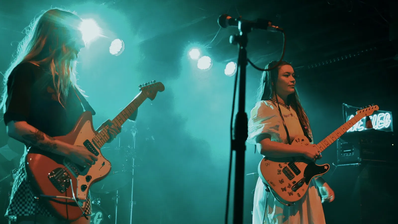 a couple of women playing guitars