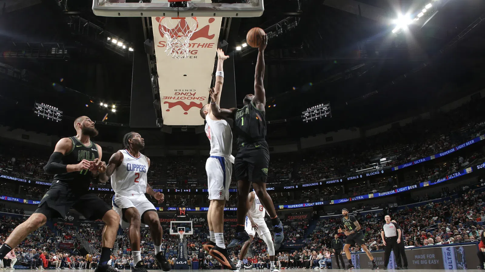 a basketball player jumping to dunk a basketball