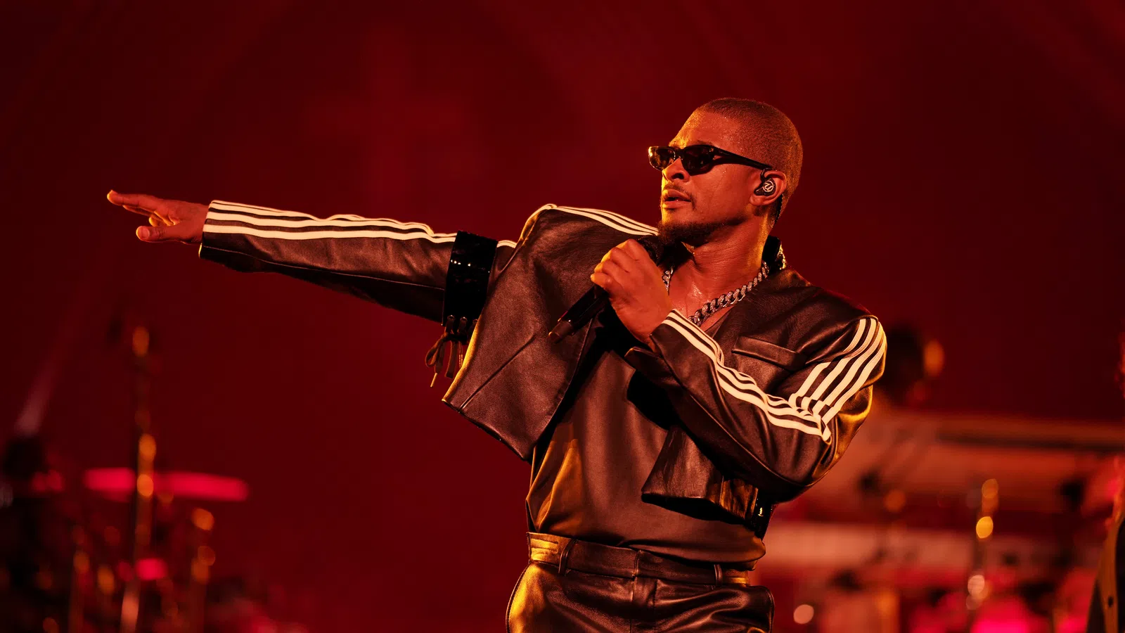 a man wearing sunglasses and a microphone
