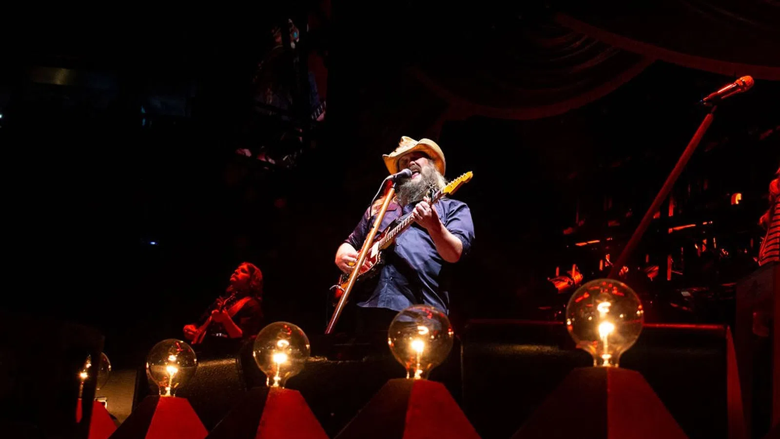 a person playing a guitar on a stage
