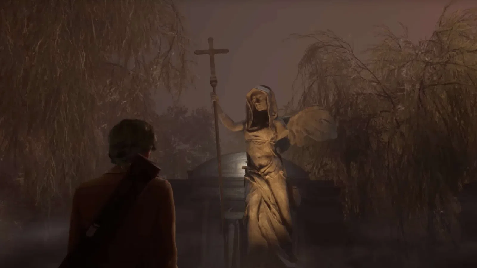 Person facing eerie stone angel statue holding a cross in a foggy, dimly lit, wooded cemetery at night