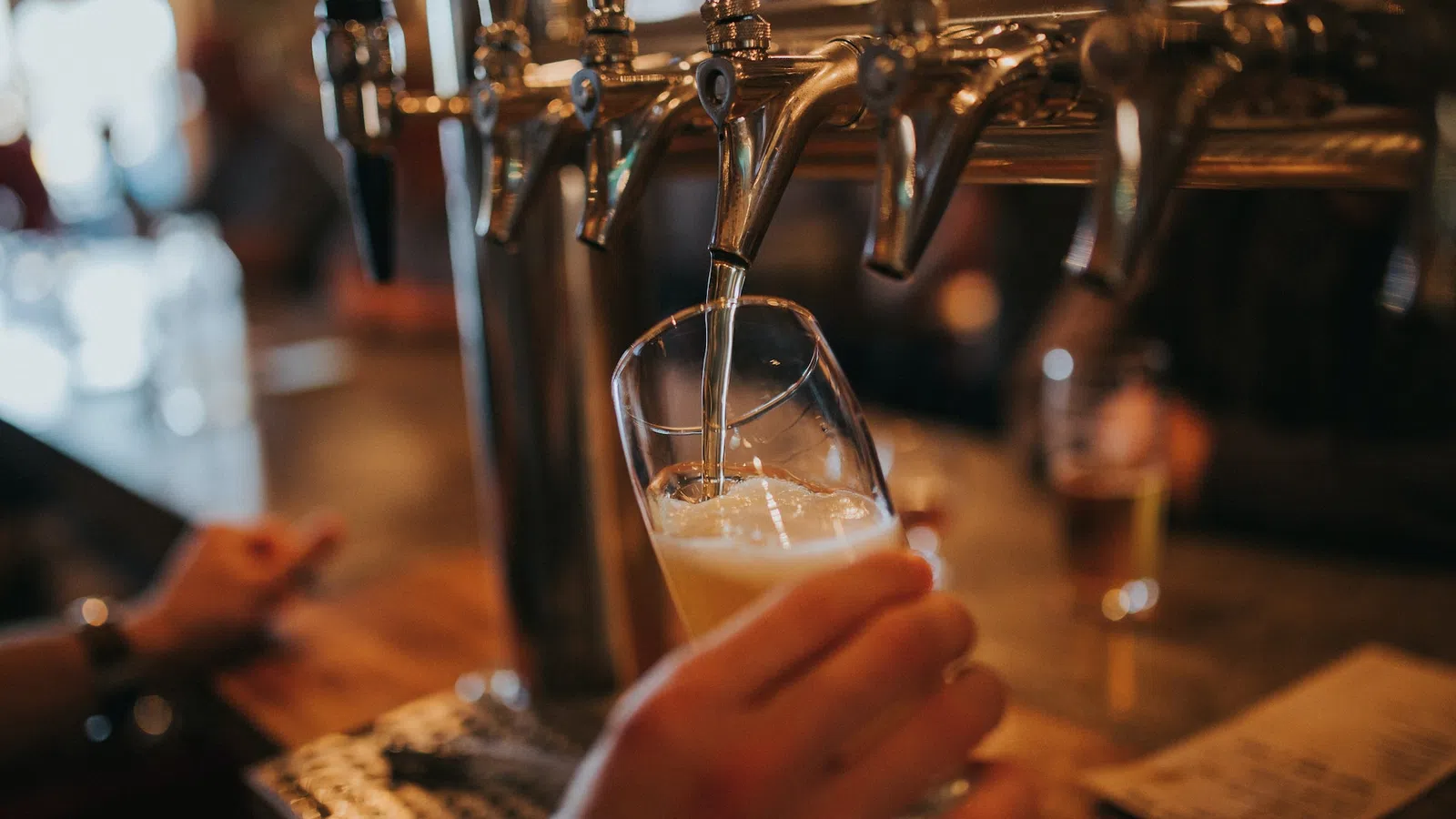 a hand holding a glass of liquid
