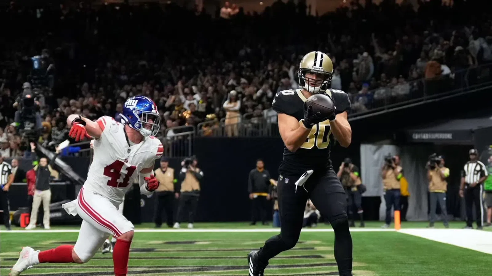 a couple of football players running on a field