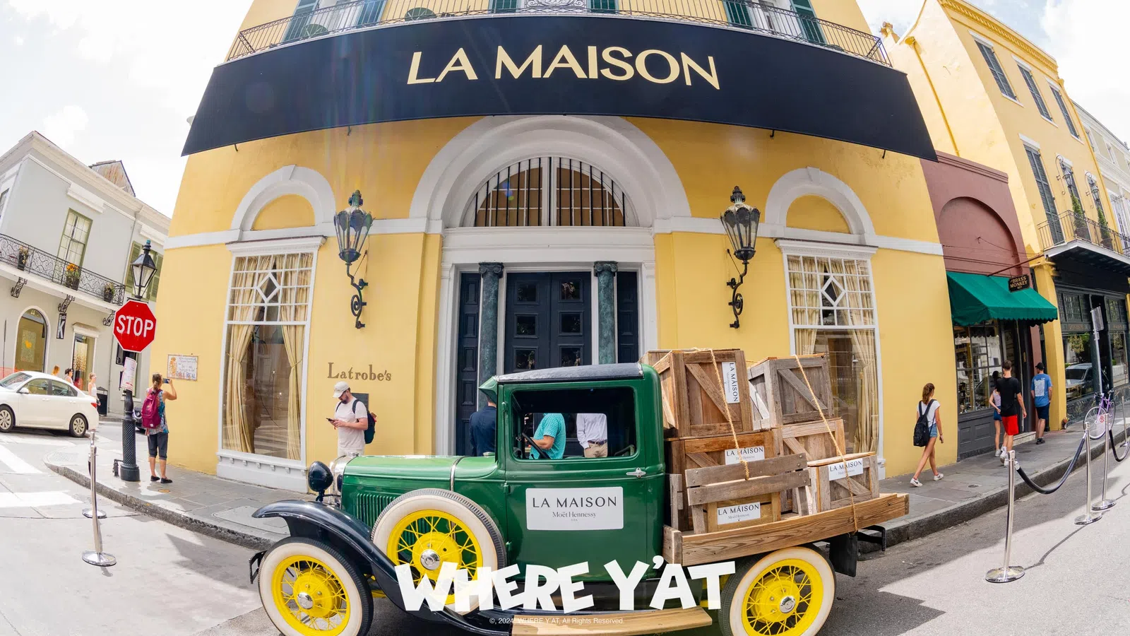 a green tractor parked outside a building