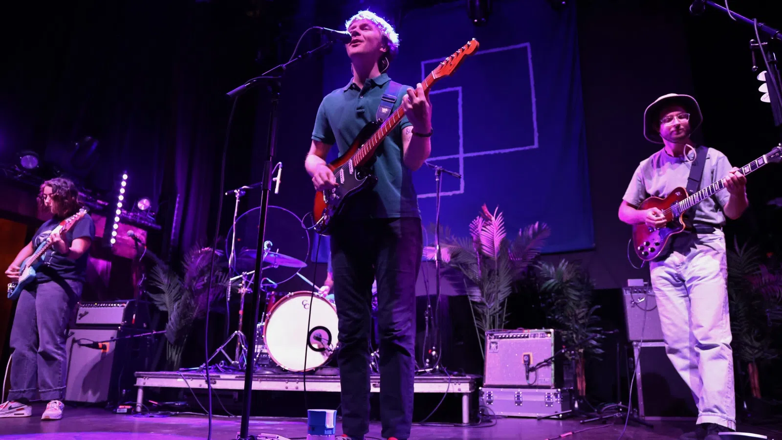 a group of people playing instruments on a stage