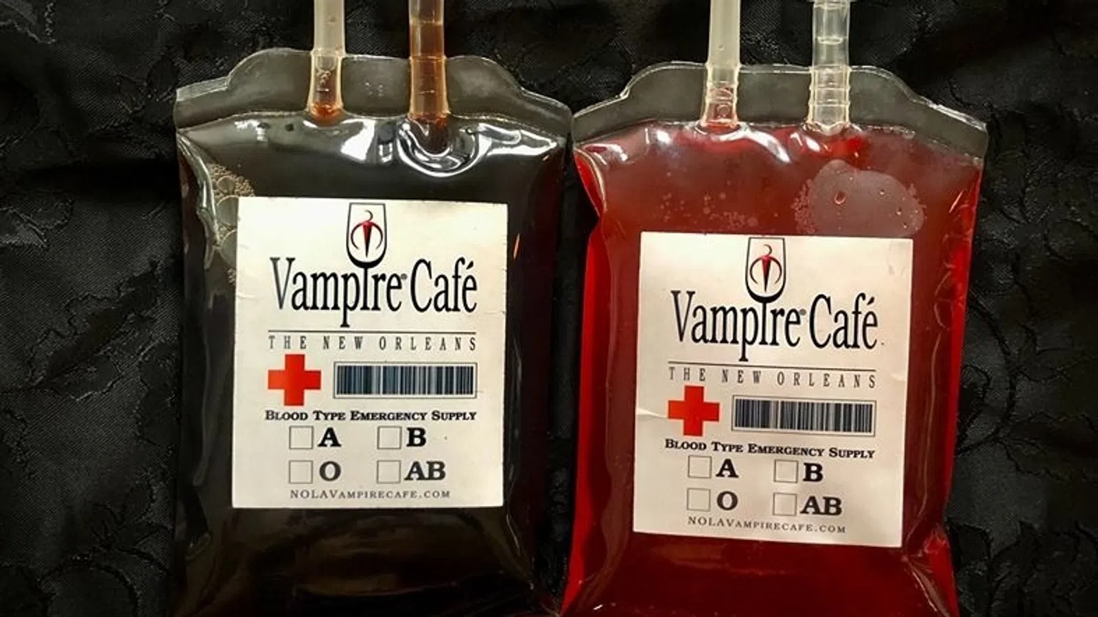 a couple of metal bottles with red labels and a cross on them