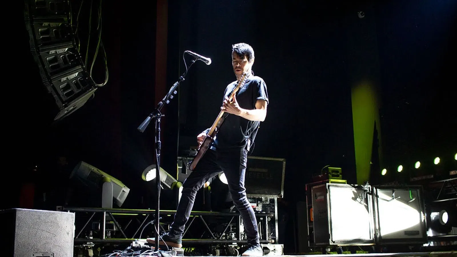 a man playing a guitar on a stage