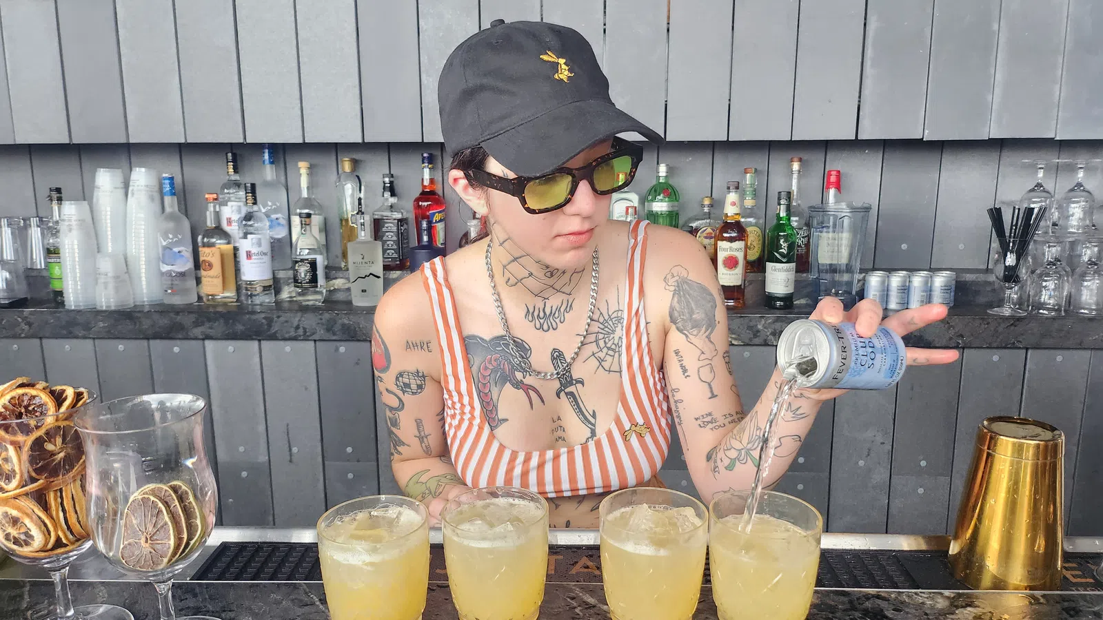 a person pouring a drink into a glass