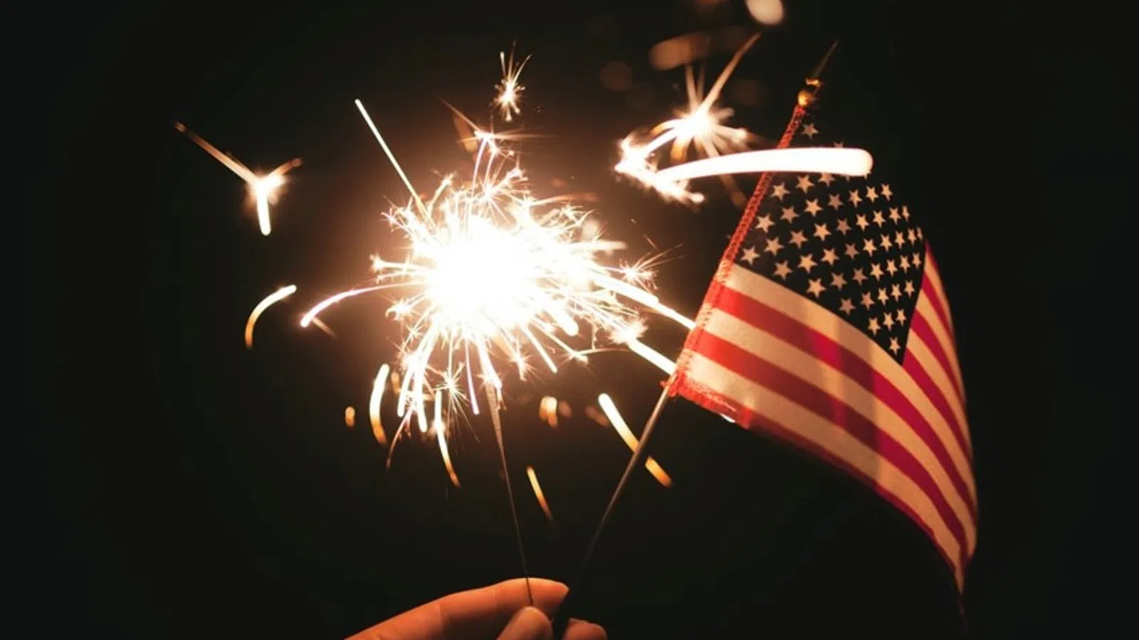 a flag with fireworks in the background