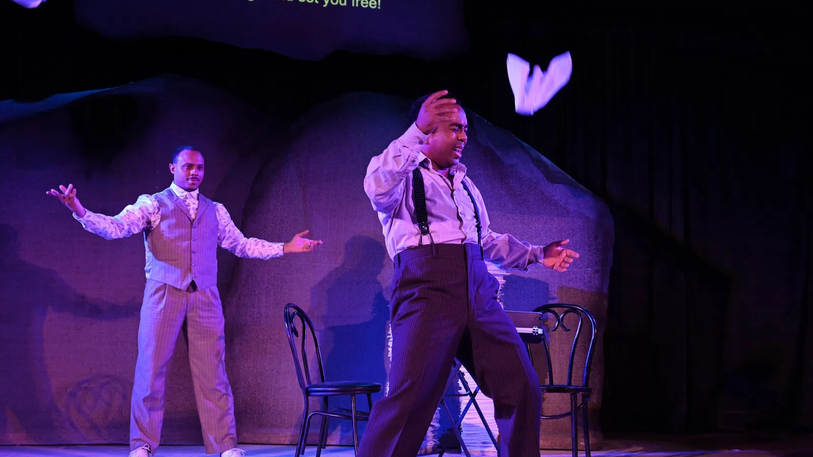 a couple of men dancing on a stage