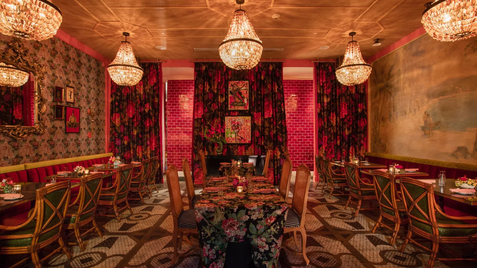 Elegant restaurant interior with floral patterns, crystal chandeliers, wooden chairs, and a warm, cozy atmosphere.