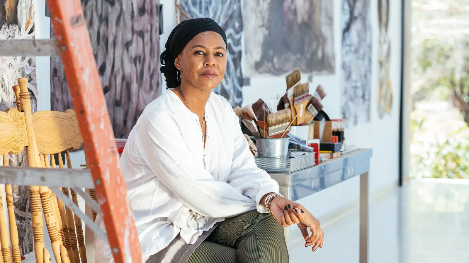 Wangechi Mutu sitting on a chair
