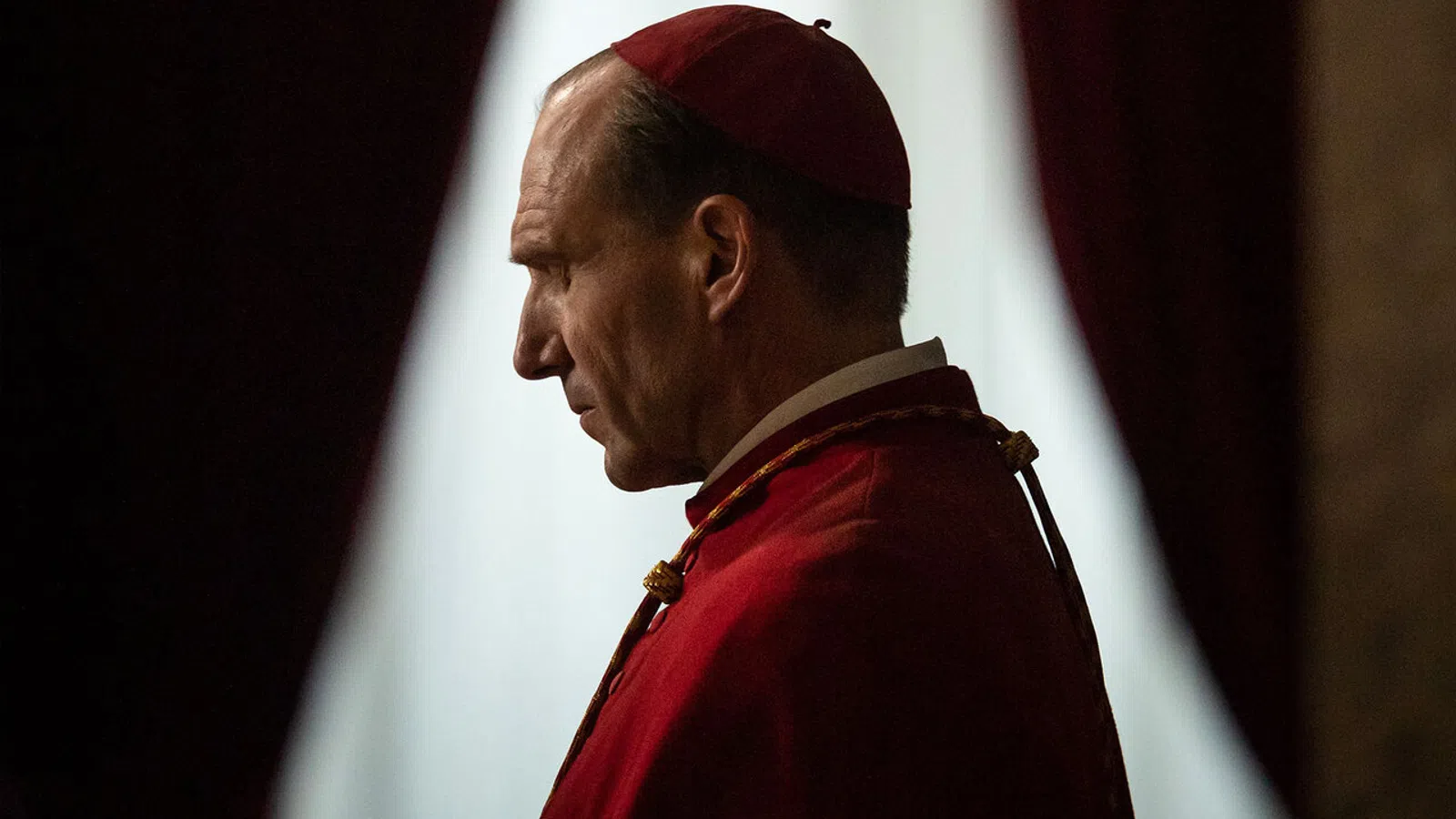 a man in a red hat and gown