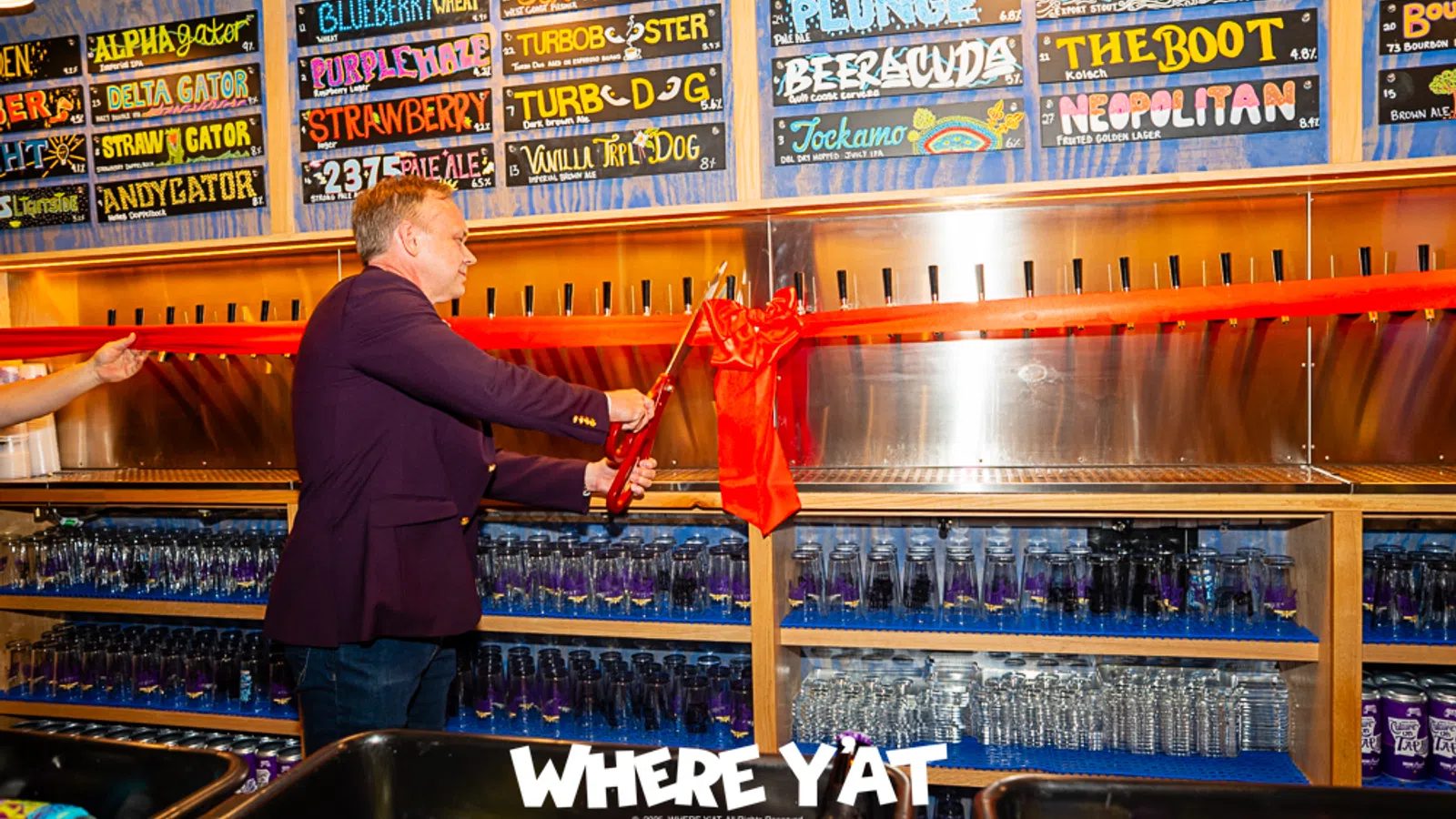 a person standing in front of a bar with a red cloth from the ceiling