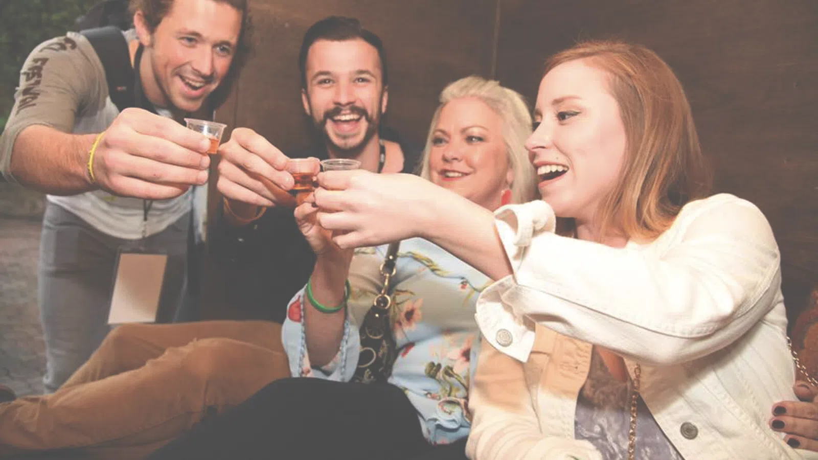 a group of people holding drinks