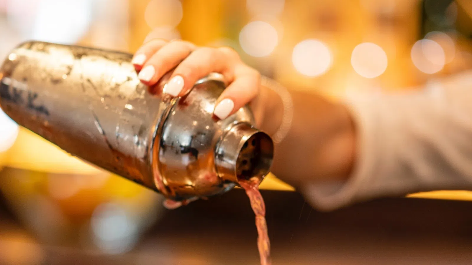 a person pouring liquid into a bottle