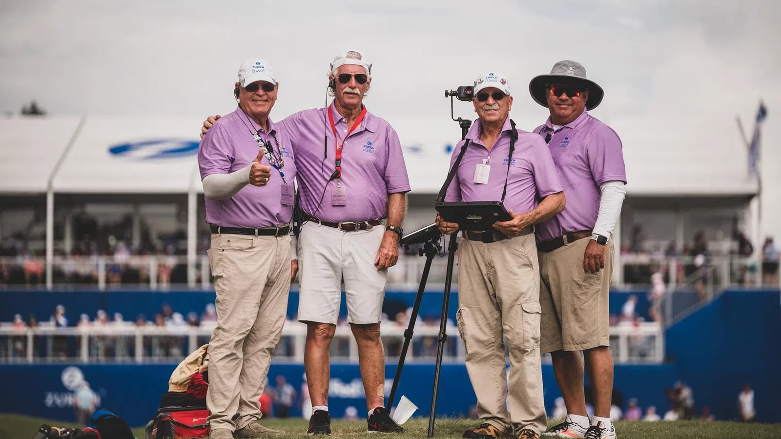 a group of men standing on a golf course