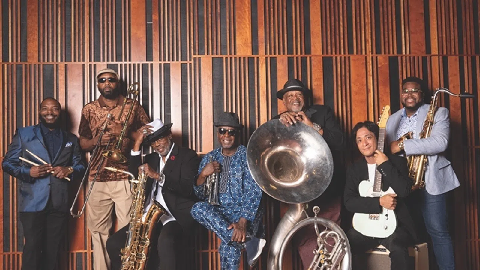 a group of people posing for a photo with instruments